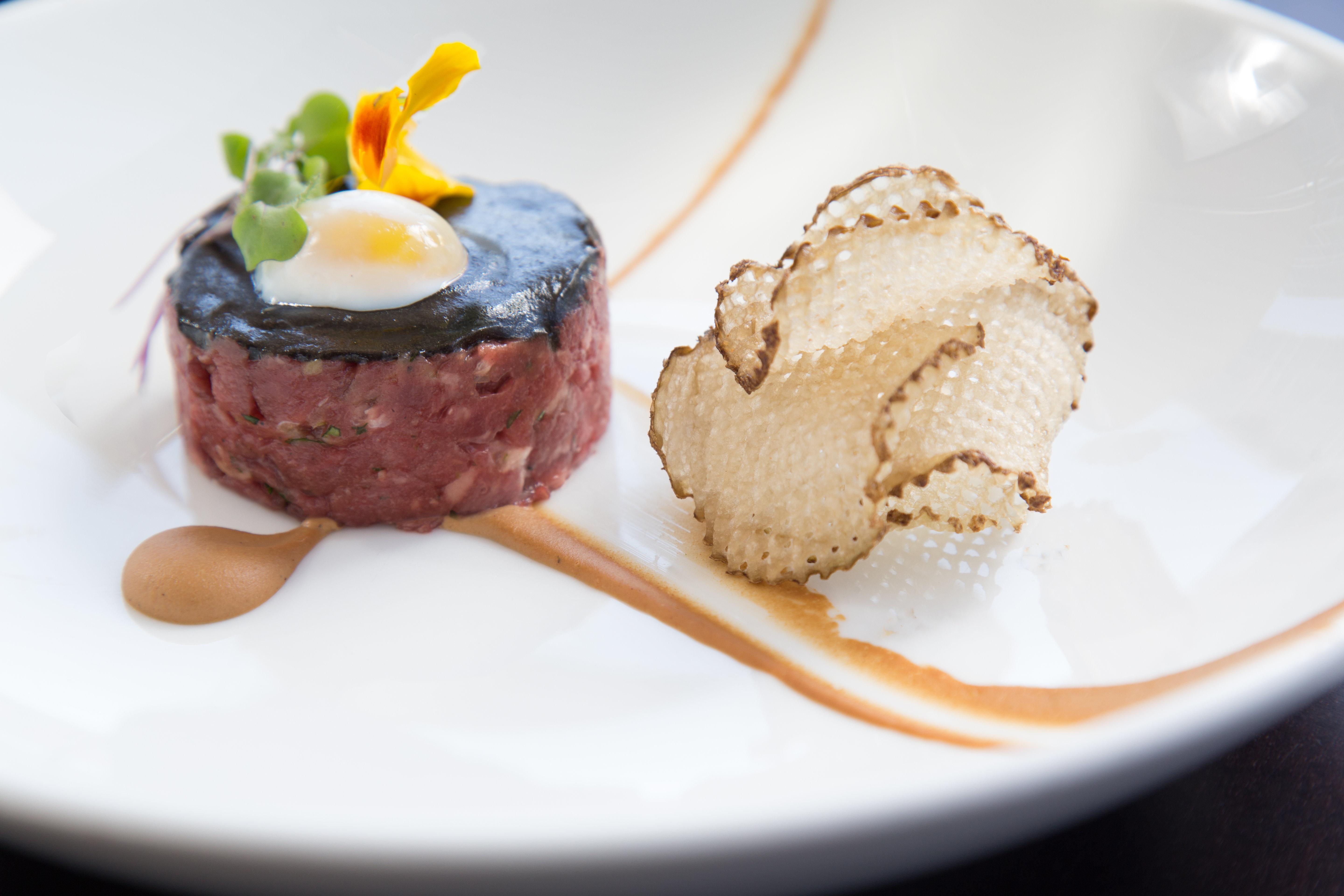 Kimpton Epic Hotel By Ihg Miami Exterior photo A dish of beef tartar with a slice of black truffle